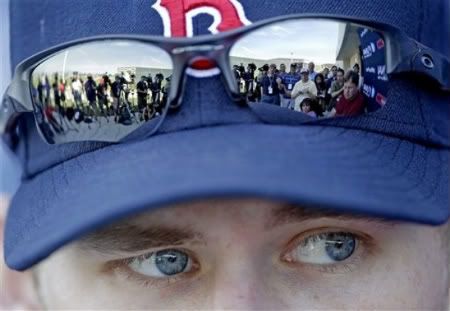 Members of the media are reflected in the sunglasses of Boston Red Sox pitcher Daniel Bard as he speaks during a news conference following a baseball spring training workout Tuesday, Feb. 21, 2012, in Fort Myers, Fla.