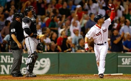 Cody Ross #7 of the Boston Red Sox drops his bat and watches the ball after hitting the game winning walk-off three run home run in the bottom of the ninth inning against the Chicago White Sox during the game on July 19, 2012 at Fenway Park in Boston, Massachusetts.