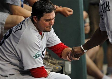 Boston Red Sox starting pitcher Josh Beckett reacts with a teammate as he sits on the bench after being relieved during the eighth inning of an interleague baseball game against the Philadelphia Phillies, Sunday, May 20, 2012, in Philadelphia. 