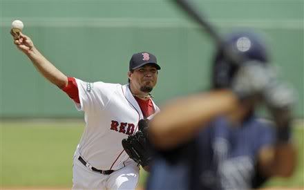 Boston Red Sox starter Josh Beckett delivers to Tampa Bay Rays batter Desmond Jennings during the first inning of a spring training baseball game in Fort Myers, Fla., Tuesday, March 27, 2012.