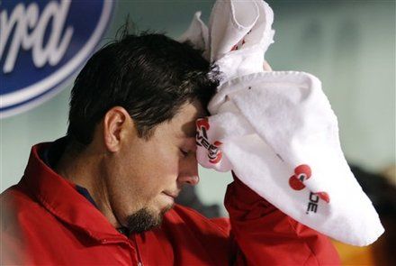 Boston Red Sox starting pitcher Josh Beckett wipes his head in the dugout after being taken out in the third inning of a baseball game against the Cleveland Indians in Boston, Thursday, May 10, 2012.
