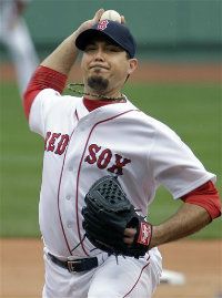 Boston Red Sox starting pitcher Josh Beckett delivers to the Seattle Mariners in the first inning of a baseball game at Fenway Park in Boston, Tuesday, May 15, 2012.