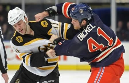 New York Rangers' Stu Bickel, right, fights with Boston Bruins' Gregory Campbell during the first period of an NHL hockey game Sunday, March 4, 2012, at Madison Square Garden in New York.