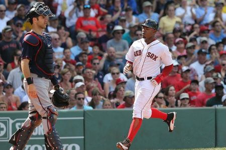 Carl Crawford #13 of the Boston Red Sox scores a run as Ryan Doumit #18 of the Minnesota Twins defends the plate in the seventh inning at Fenway Park August 5, 2012 in Boston, Massachusetts.