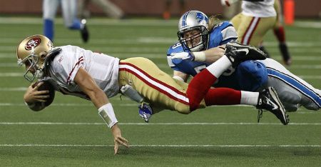 Bobby Carpenter #59 of the Detroit Lions dives to tackle Alex Smith #11 of the San Francisco 49ers during a NFL game against the at Ford Field on October 16, 2011 in Detroit, Michigan.