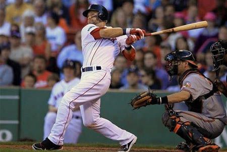Boston Red Sox's Cody Ross hits an RBI double off a pitch by Baltimore Orioles' Luis Ayala allowing Red Sox's Dustin Pedroia to score in the eighth inning of a baseball game at Fenway Park, in Boston, Sunday, Sept. 23, 2012. 