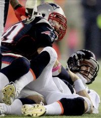 Denver Broncos quarterback Peyton Manning, right, watches his fumble after being sacked by New England Patriots defensive end Rob Ninkovich (50) in the third quarter of an NFL football game, Sunday, Oct. 7, 2012, in Foxborough, Mass.
