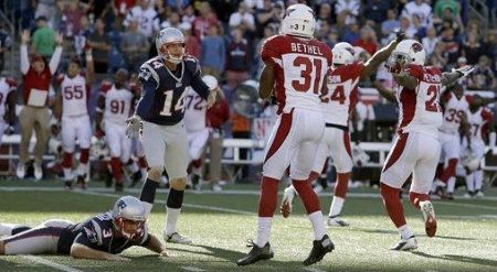 New England Patriots kicker Stephen Gostkowski (3) lies on the field alongside Arizona Cardinals cornerback Justin Bethel (31) after missing a field goal at the end of the fourth quarter of an NFL football game on Sunday, Sept. 16, 2012, in Foxborough, Mass. Patriot's Zoltan Mesko (14), the holder on the play, reacts.