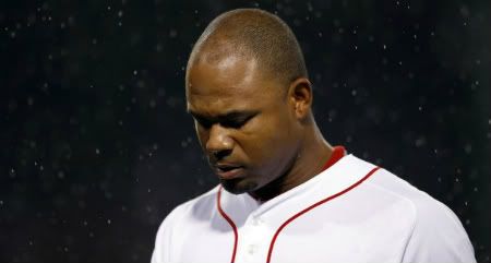 Boston Red Sox Carl Crawford walks back to the dugout after popping-out to end the second inning of their MLB American League baseball game against the Tampa Bay Rays at Fenway Park in Boston, Massachusetts, September 15, 2011.