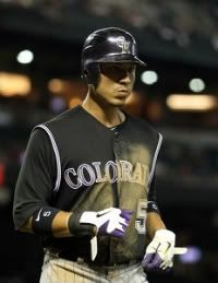 Carlos Gonzalez #5 of the Colorado Rockies walks off the field during the Major League Baseball game against the Arizona Diamondbacks at Chase Field on August 29, 2011 in Phoenix, Arizona.