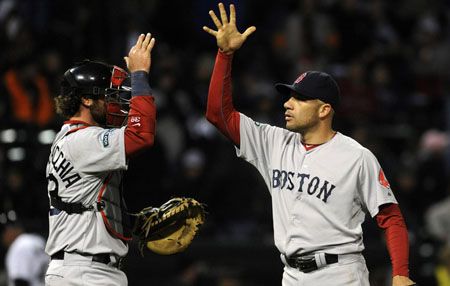 Alfredo Aceves #91 of the Boston Red Sox and Jarrod Saltalamacchia #39 celebrate their victory against the Chicago White Sox on April 28, 2012 at U.S. Cellular Field in Chicago, Illinois.