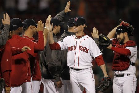 Clay Buchholz #11 of the Boston Red Sox is congratulated by teammates after their 7-0 win over the Baltimore Orioles in the game at Fenway Park on June 7, 2012 in Boston, Massachusetts. 