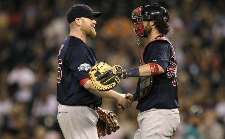 Boston Red Sox starting pitcher Aaron Cook, left, greets catcher Jarrod Saltalamacchia, right, after Cook threw a two-hit shutout against the Seattle Mariners in a baseball game, Friday, June 29, 2012, in Seattle. 