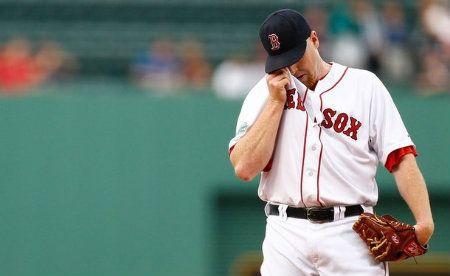  Aaron Cook #35 of the Boston Red Sox wipes the sweat off of his face in between pitches against the Detroit Tigers during the game on August 1, 2012 at Fenway Park in Boston, Massachusetts.