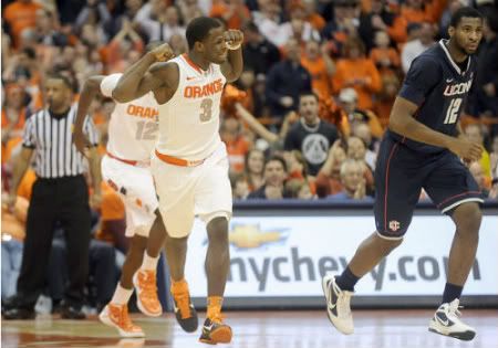 Syracuse's Dion Waiters flexes his muscles after scoring against Connecticut
