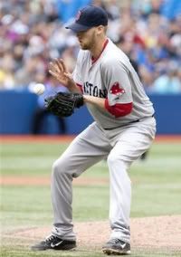 Boston Red Sox relief pitcher Daniel Bard fields a ball off the bat of Toronto Blue Jays' Brett Lawrie in the ninth inning of a baseball game in Toronto, Monday, Sept. 5, 2011. The Blue Jays defeated the Red Sox 1-0 in 11 innings.