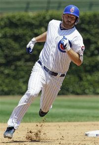 Chicago Cubs' Ryan Dempster runs to third base after hitting a triple during the second inning of an interleague baseball game against the Boston Red Sox in Chicago, Friday, June 15, 2012.