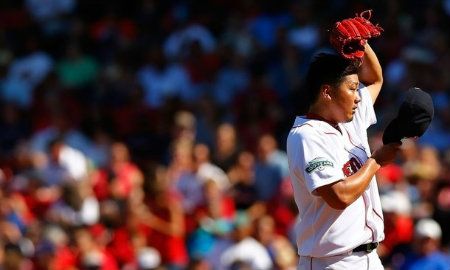  Daisuke Matsuzaka #18 of the Boston Red Sox wipes the sweat off of his face in between pitches against the Kansas City Royal during the game on August 27, 2012 at Fenway Park in Boston, Massachusetts.