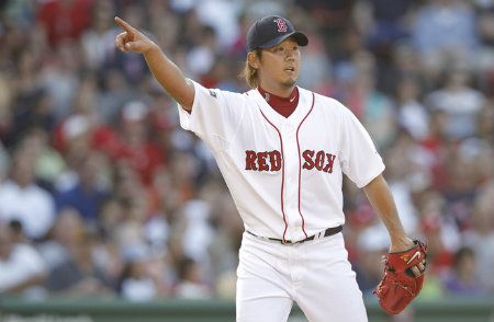 Daisuke Matsuzaka #18 of the Boston Red Sox points to a Washington Nationals baserunner during the fourth inning of the game at Fenway Park on June 9, 2012 in Boston, Massachusetts. 