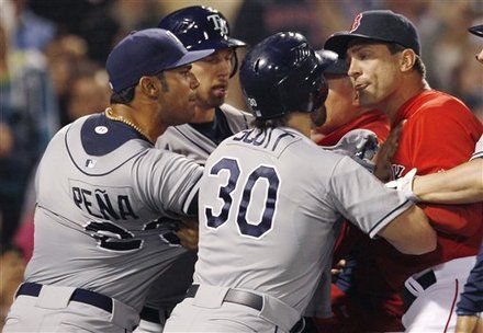 Tampa Bay Rays' Carlos Pena, left, and Luke Scott, center, argue with Boston Red Sox bench coach Tim Bogar after benches cleared in the ninth inning of a baseball game at Fenway Park in Boston, Friday, May 25, 2012. Scott was hit by a pitch thrown by Red Sox pitcher Franklin Morales, leading to the fracas.