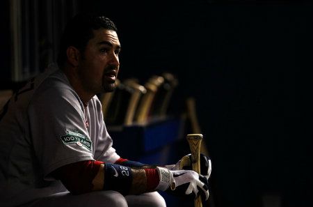 Adrian Gonzalez #28 of the Boston Red Sox looks on from the dugout during a game against the Miami Marlins at Marlins Park on June 11, 2012 in Miami, Florida. 