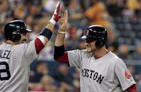 Adrian Gonzalez #28 and Will Middlebrooks #64 of the Boston Red Sox celebrate run against the Toronto Blue Jays during MLB action at The Rogers Centre June 2, 2012 in Toronto, Ontario, Canada.