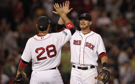 Will Middlebrooks #64 of the Boston Red Sox is congratulated by Adrian Gonzalez #28 after they defeated the Atlanta Braves in an interleague game at Fenway Park on June 23, 2012 in Boston, Massachusetts.
