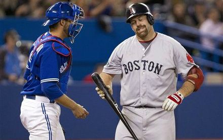 Boston Red Sox Kevin Youkilis, right, reacts in front of Toronto Blue Jays catcher J.P. Arencibia after striking out during ninth inning of a baseball game in Toronto on Wednesday, April 11, 2012.