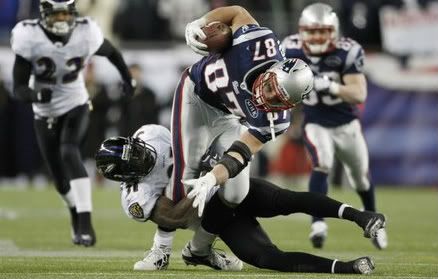 New England Patriots tight end Rob Gronkowski is tackled by Baltimore Ravens strong safety Bernard Pollard in the third quarter during the NFL AFC Championship football game in Foxborough, Massachusetts, January 22, 2012