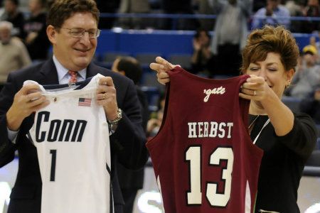  UConn President Susan Herbst and her brother Jeffrey, President of Colgate, exchanged team jerseys before the start of the UConn - Colgate women's basketball game at the XL Center Wednesday night in Hartford. 