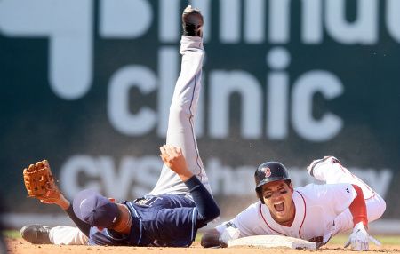 Jacoby Ellsbury #2 of the Boston Red Sox reacts after he was injured in a double play in the bottom of the fourth inning by Reid Brignac #15 of the Tampa Bay Rays the Tampa Bay Rays during the home opener on April 13, 2012 at Fenway Park in Boston, Massachusetts.