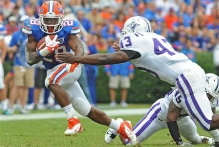 Florida running back Jeff Demps (28) tries to get away from Furman linebacker Matt Solomon (43) during the first half of an NCAA college football game in Gainesville, Fla. , on Saturday, Nov. 19, 2011.