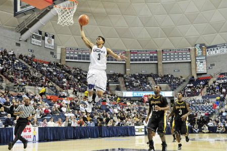 UConn's Jeremy Lamb hits a breakaway dunk with AIC's D.J. Gutridge (15) and Spencer Braithwaite trailing during the first half of an exhibition game at Gampel Pavilion in Storrs.