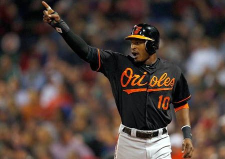 Adam Jones #10 of the Baltimore Orioles reacts after scoring his second run of the game in the sixth inning against the Boston Red Sox at Fenway Park on September 21, 2012 in Boston, Massachusetts.