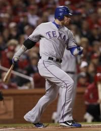 Texas Rangers' Josh Hamilton hits a RBI single against the St. Louis Cardinals during the first inning in Game 6 of MLB's World Series baseball championship in St. Louis, Missouri, October 27, 2011.