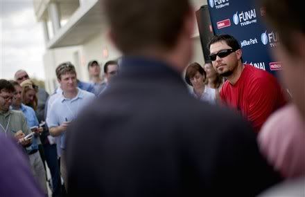 Boston Red Sox pitcher Josh Beckett, right, answers questions from reporters during a new conference as pitchers and catchers officially report to baseball spring training on Sunday, Feb. 19, 2012, in Fort Myers, Fla.