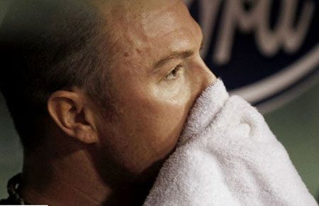 Jon Lester #31 of the Boston Red Sox wipes his face in the dugout after giving up two runs to the Atlanta Braves during the fourth inning of the interleague game at Fenway Park on June 22, 2012 in Boston, Massachusetts.