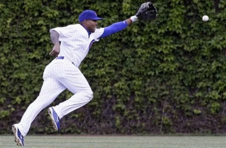 Chicago Cubs center fielder Marlon Byrd chases a triple hit by Cincinnati Reds' Todd Frazler during the ninth inning of a baseball game in Chicago, Friday, April 20, 2012.