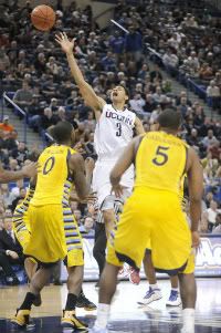 UConn's Jeremy Lamb loses the ball on the way to the basket as Marquette's Jamil Wilson and Junior Cadougan look on. 