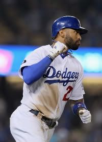 Matt Kemp #27 of the Los Angeles Dodgers pumps his fist as he rounds first base after hitting a two-run home run against the San Francisco Giants in the eighth inning at Dodger Stadium on September 22, 2011 in Los Angeles, California.