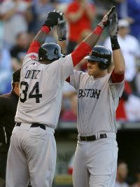 Will Middlebrooks #64 of the Boston Red Sox celebrates his three-run home run with David Ortiz #34 during a game against the Kansas City Royals at Kauffman Stadium May 7, 2012 in Kansas City, Missouri.