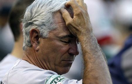 Boston Red Sox manager Bobby Valentine reacts in the dugout during a baseball game against the Texas Rangers, Wednesday, July 25, 2012, in Arlington, Texas. 