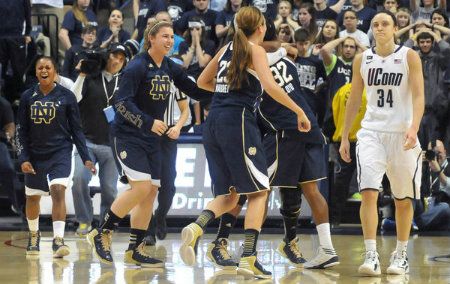 UConn's Kelly Faris, right, returns to the bench as Notre Dame players celebrate their victory at Gampel Pavilion Saturday afternoon. 