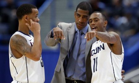 Huskies head coach Kevin Ollie talks with guards Shabazz Napier, left, and Ryan Boatright during a break in the action against the New Hampshire Wildcats Nov. 29.