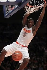 Syracuse's Dion Waiters hangs on the rim after slamming the ball during the quarterfinal round of the Big East NCAA college basketball conference tournament against Connecticut in New York, Thursday, March 8, 2012.