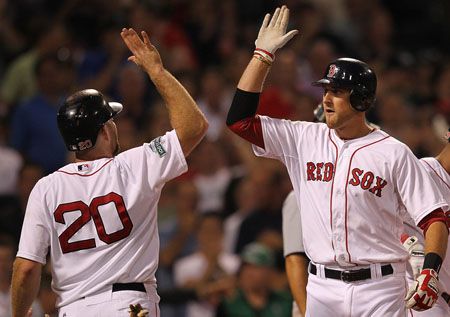 Will Middlebrooks #64 of the Boston Red Sox celebrates with Kevin Youkilis #20 after Middlebrooks hit a two-run home run against the Detroit Tigers in the fourth inning at Fenway Park May 30, 2012 in Boston, Massachusetts