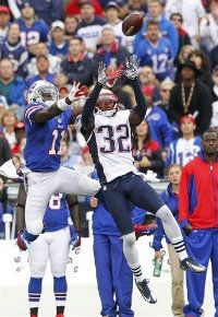 New England Patriots' Devin McCourty (32) intercepts a pass intended for Buffalo Bills' T. J. Graham (11) during the first half of an NFL football game in Orchard Park, N.Y., Sunday, Sept. 30, 2012.