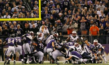 Kicker Justin Tucker #9 of the Baltimore Ravens kicks the game winning field goal to give the Ravens a 31-30 win over the New England Patriots at M&T Bank Stadium on September 23, 2012 in Baltimore, Maryland.