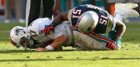 Ryan Tannehill #17 of the Miami Dolphins is sacked by Jerod Mayo #51 of the New England Patriots during a game at Sun Life Stadium on December 2, 2012 in Miami Gardens, Florida.