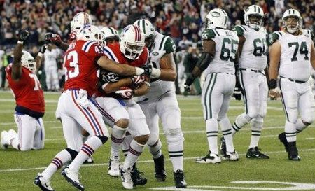 New England Patriots defensive end Rob Ninkovich, center, runs with a recovered fumble after he sacked New York Jets quarterback Mark Sanchez to seal an 29-26 overtime win in an NFL football game in Foxborough, Mass., Sunday, Oct. 21, 2012. Celebrating at left is Patriots defensive tackle Vince Wilfork (75) as Jets linemen Brandon Moore (65), D'Brickashaw Ferguson (60) and Nick Mangold (74) walk off.